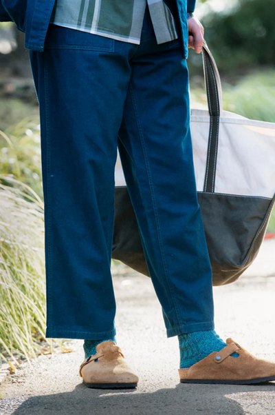 A man wearing a pair of Rototo blue socks