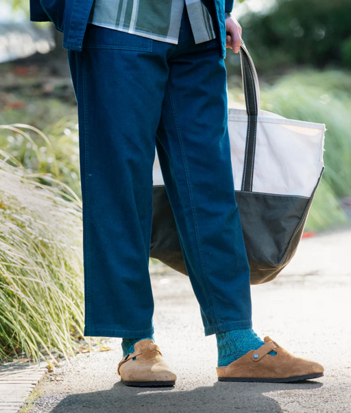 A man wearing a pair of Rototo blue socks