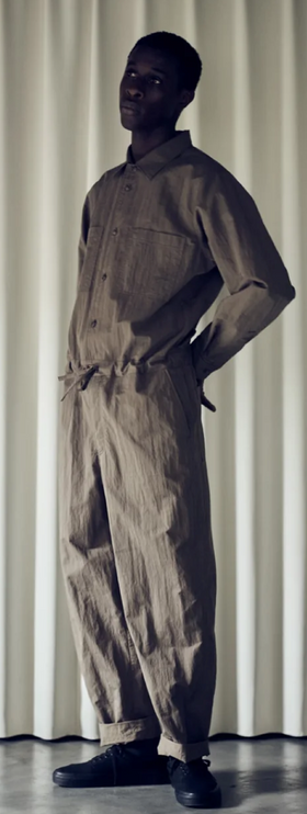 A man wearing a Still By Hand full outfit in dark green