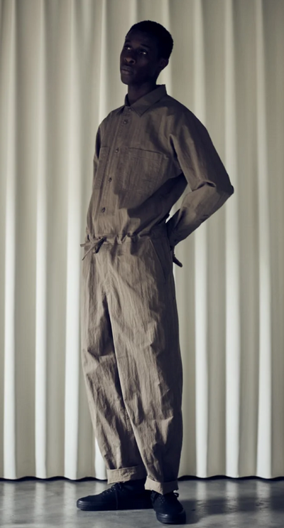 A man wearing a Still By Hand full outfit in dark green