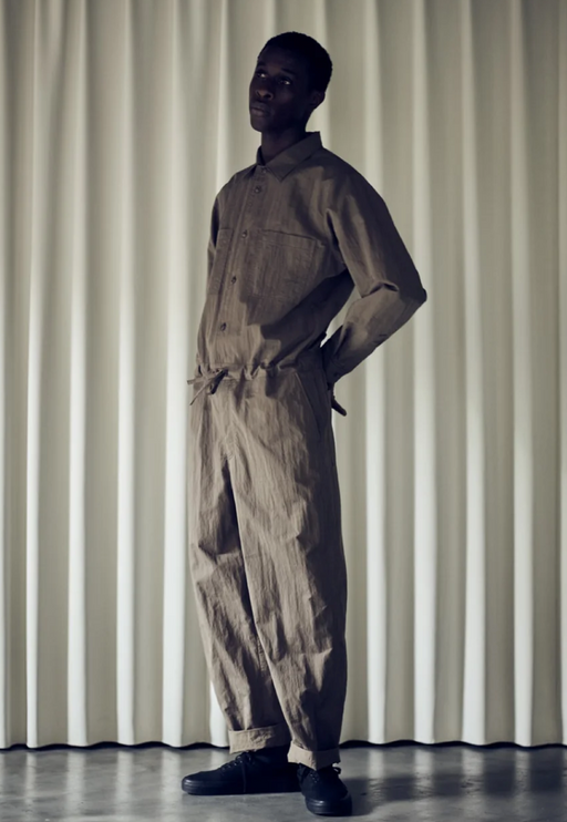 A man wearing a Still By Hand full outfit in dark green