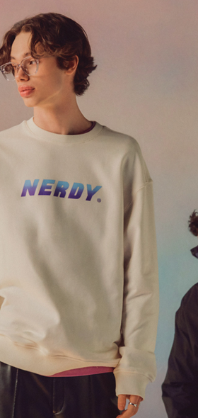 A man wearing a Nerdy branded crewneck in beige and blue