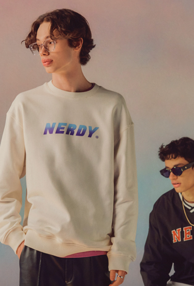 A man wearing a Nerdy branded crewneck in beige and blue