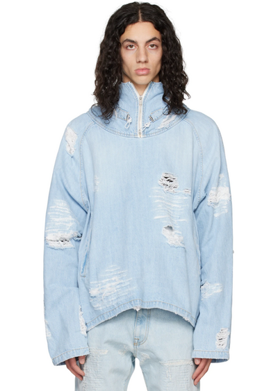 A man wearing a baby blue ripped denim jacket by the clothing brand 424