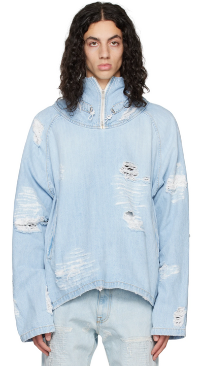 A man wearing a baby blue ripped denim jacket by the clothing brand 424