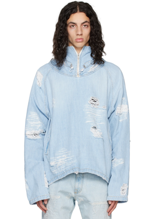 A man wearing a baby blue ripped denim jacket by the clothing brand 424