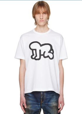 A man wearing a Junya Watanabe white graphic t-shirt and jeans