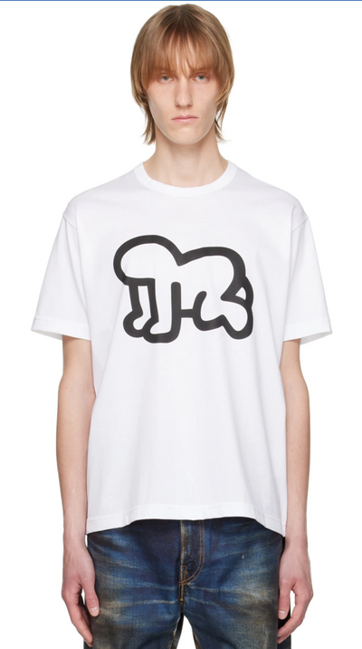 A man wearing a Junya Watanabe white graphic t-shirt and jeans