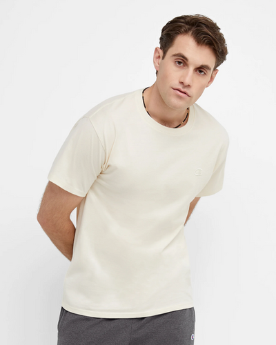 A man wearing a white Champion t-shirt