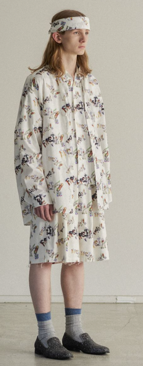 A man wearing an all over print Facetasm outfit with a matching bandana