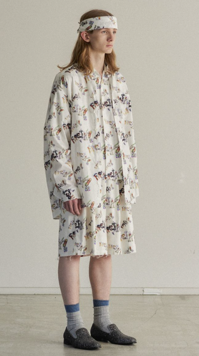 A man wearing an all over print Facetasm outfit with a matching bandana