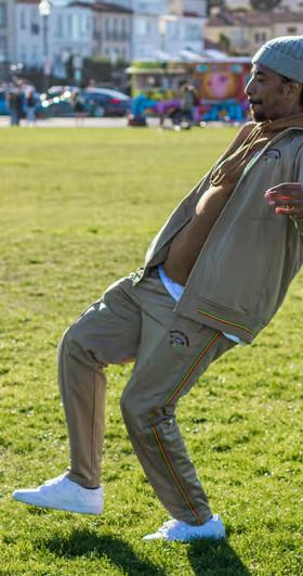 A man volleying a soccer ball while wearing a LRG clothing outfit