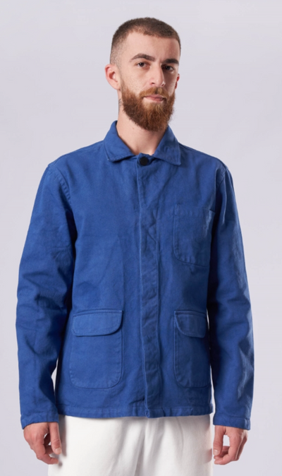 A man wearing a La Paz denim shirt with white pants