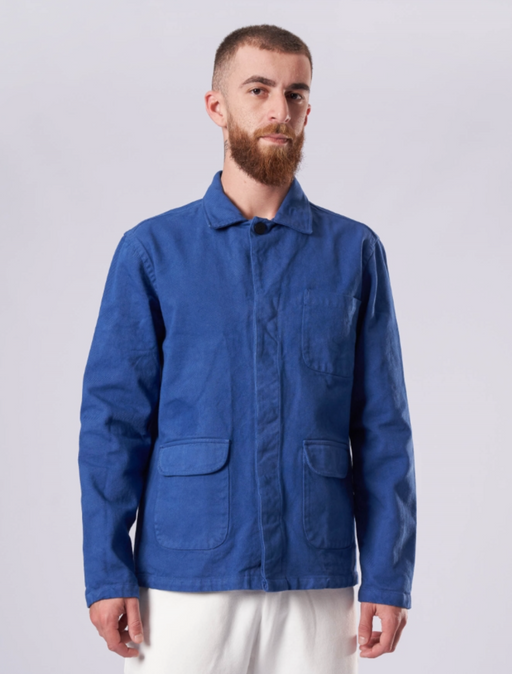 A man wearing a La Paz denim shirt with white pants