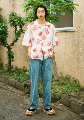 A man wearing an all over print Edwin button up with jeans