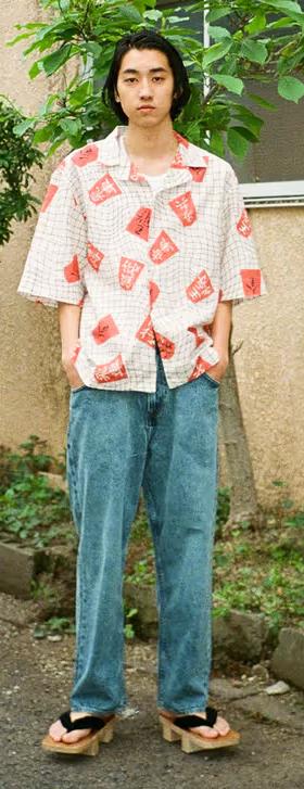A man wearing an all over print Edwin button up with jeans