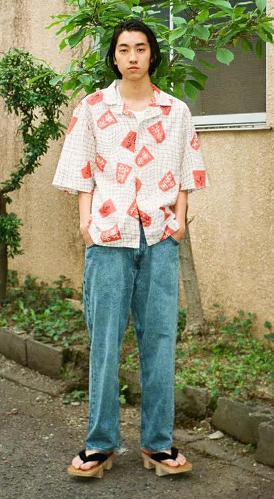 A man wearing an all over print Edwin button up with jeans
