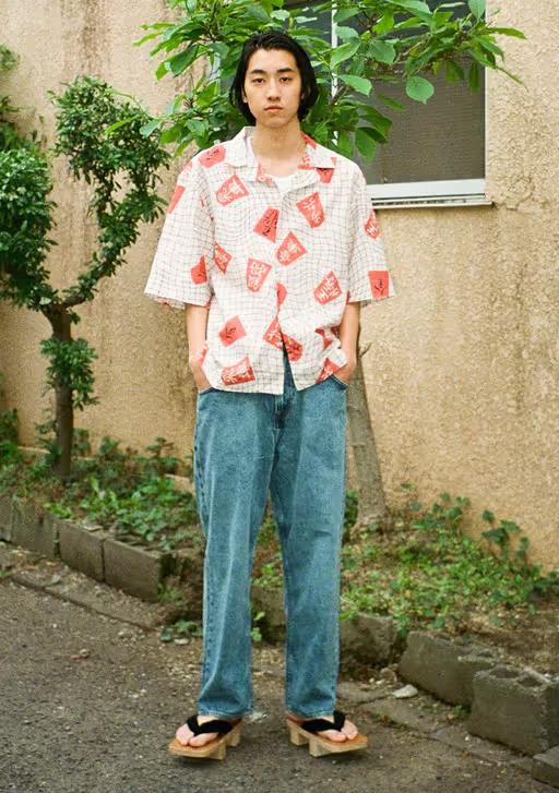 A man wearing an all over print Edwin button up with jeans