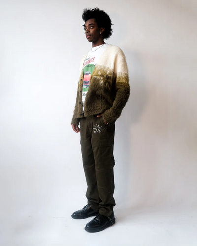 A man wearing a Jehucal cardigan a white print t-shirt