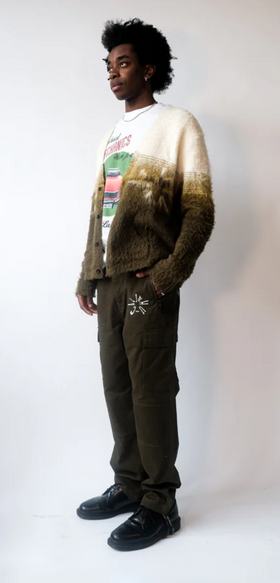 A man wearing a Jehucal cardigan a white print t-shirt