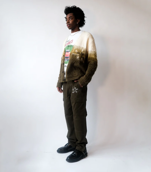 A man wearing a Jehucal cardigan a white print t-shirt