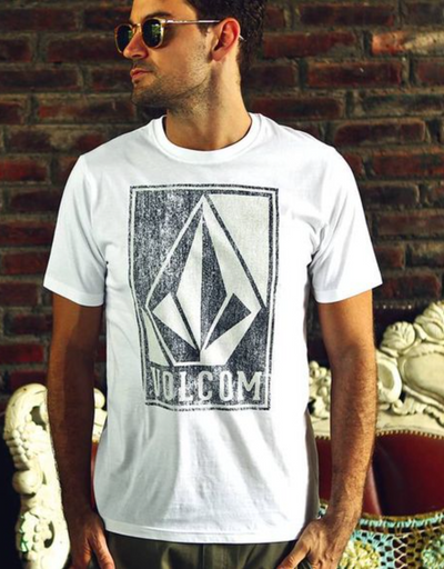 A man wearing a Volcom logo icon t-shirt in white and sunglasses