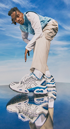 A man wearing blue asics running shoes