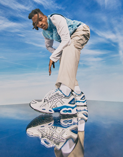 A man wearing blue asics running shoes