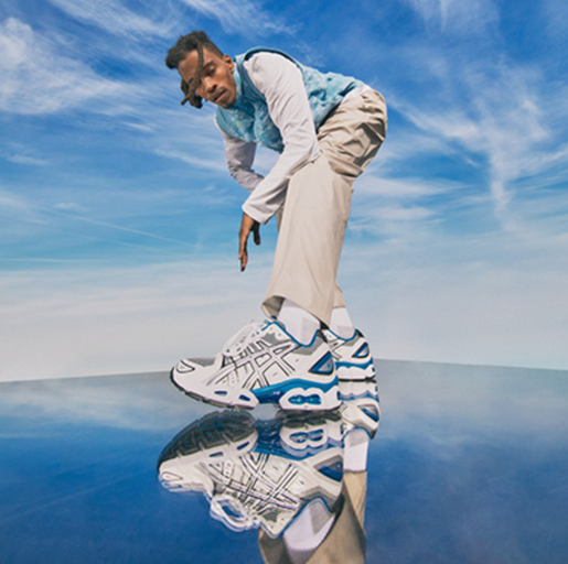 A man wearing blue asics running shoes