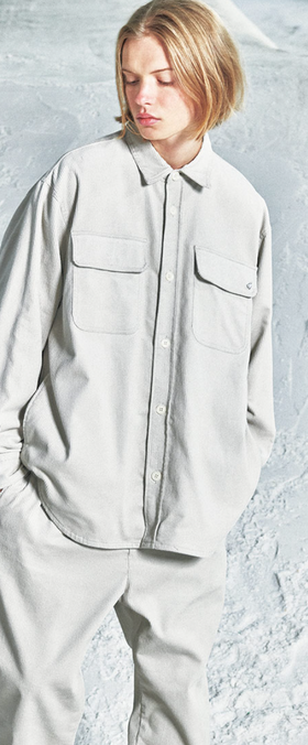 A woman wearing a space grey SOPHNET. button up and matching pants