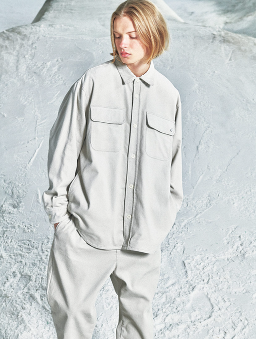 A woman wearing a space grey SOPHNET. button up and matching pants
