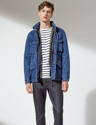 A man wearing a denim GAP jacket along with a striped shirt and denim