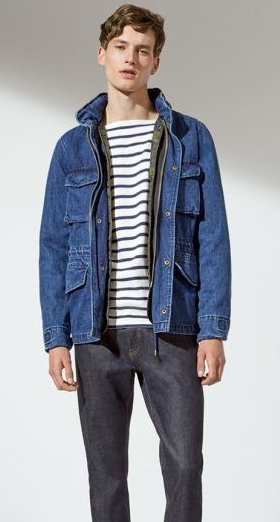 A man wearing a denim GAP jacket along with a striped shirt and denim