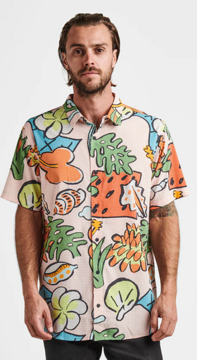 A man wearing a colorful Roark Revival short-sleeve button up