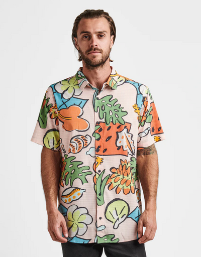A man wearing a colorful Roark Revival short-sleeve button up
