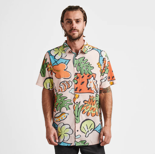 A man wearing a colorful Roark Revival short-sleeve button up