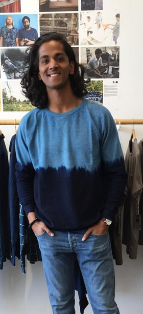 A man wearing a blue Industry of All Nations long-sleeve in the store