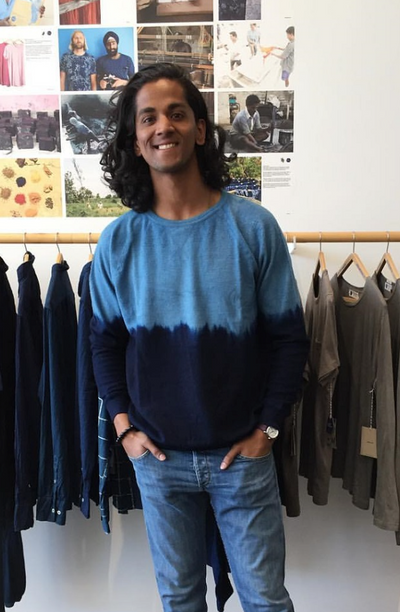 A man wearing a blue Industry of All Nations long-sleeve in the store