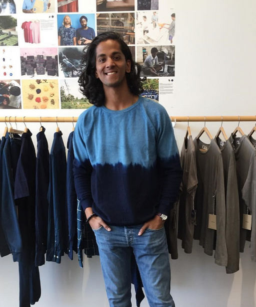 A man wearing a blue Industry of All Nations long-sleeve in the store