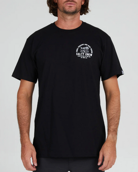 A man wearing a Salty Crew black t-shirt with a white logo on the chest