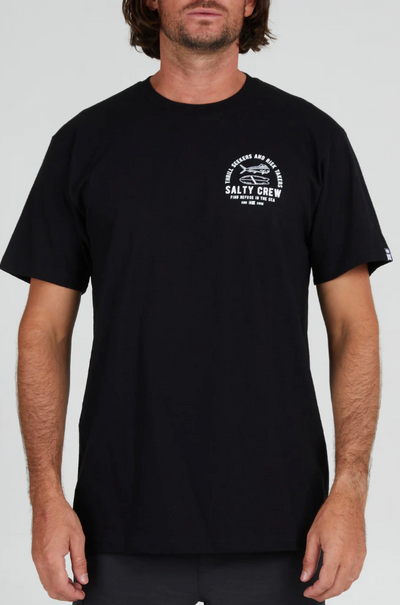 A man wearing a Salty Crew black t-shirt with a white logo on the chest