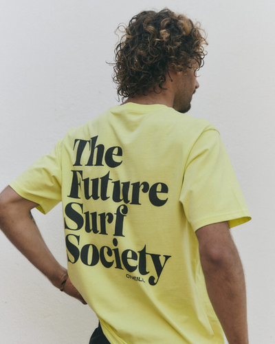 A man wearing a yellow O'Neill t-shirt that says 'the future surf society'