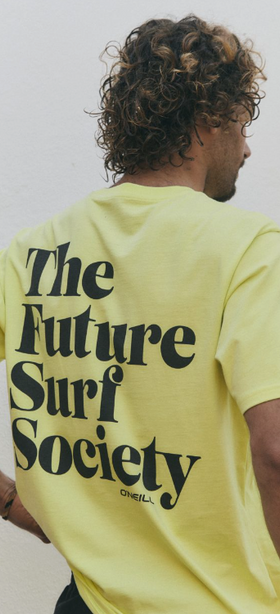 A man wearing a yellow O'Neill t-shirt that says 'the future surf society'