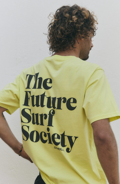 A man wearing a yellow O'Neill t-shirt that says 'the future surf society'