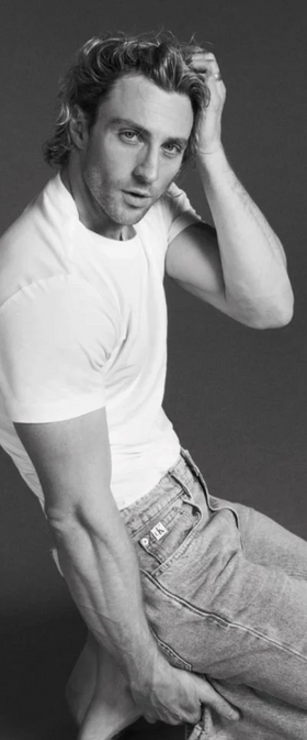 A man wearing a Calvin Klein white t-shirt and jeans