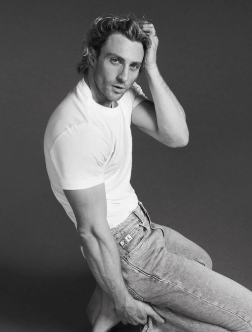 A man wearing a Calvin Klein white t-shirt and jeans
