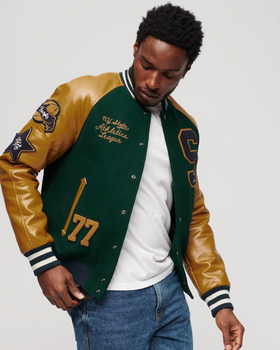 A man wearing a Superdry Varsity Jacket in green and brown