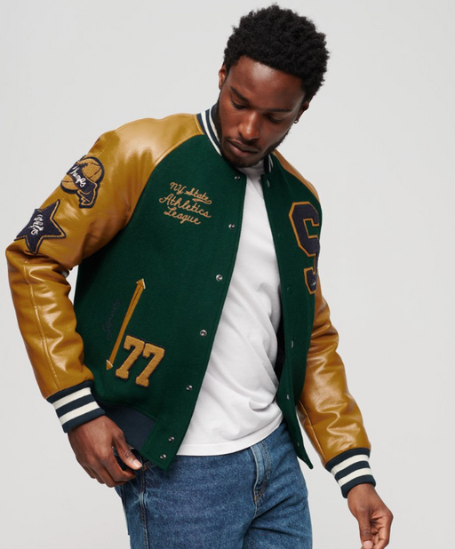 A man wearing a Superdry Varsity Jacket in green and brown