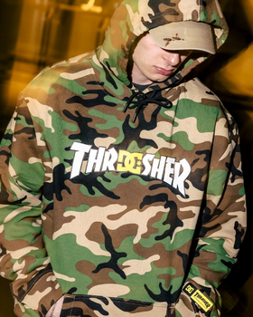 A man wearing a DC Thrasher collaboration camo hoodie