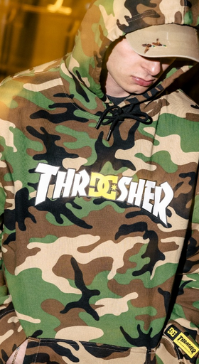 A man wearing a DC Thrasher collaboration camo hoodie